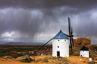 Storm clouds on windmills and castle, Consuegra, Don Quixote route, Toledo province, Castilla-La Mancha (New Castile) region, Spain, Europe