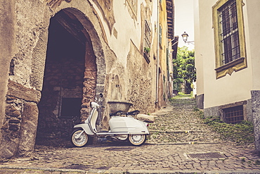 White Lambretta Innocenti scooter in the old alley, Morbegno, province of Sondrio, Valtellina, Lombardy, Italy, Europe