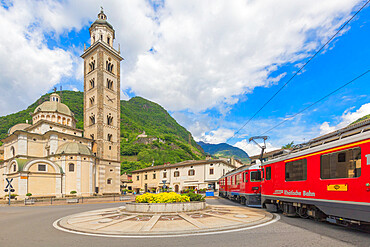 Bernina Express train next to historic Sanctuary of Madonna di Tirano, Sondrio province, Valtellina, Lombardy, Italy, Europe