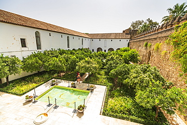 Tourists in the courtyard surrounded by defensive wall of fortress, Alcazar de los Reyes Cristianos, Cordoba, UNESCO World Heritage Site, Andalusia, Spain, Europe