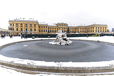 Frozen water of Naiad Fountain and snow around Schonbrunn Palace, UNESCO World Heritage Site, Vienna, Austria, Europe