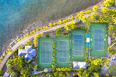 Tennis courts and palm trees in the luxury Curtain Bluff resort viewed from above, Old Road, Antigua, Leeward Islands, West Indies, Caribbean, Central America