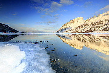 Snow capped mountains reflected in Steiropollen lake at sunrise, Lofoten Islands, Arctic, Norway, Scandinavia, Europe