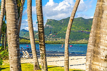 Kitesurf in the ocean seen from tropical palm-fringed beach, Le Morne Brabant, Black River district, Mauritius, Indian Ocean, Africa