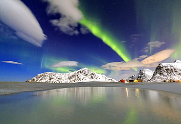 Northern Lights (aurora borealis) reflected in the cold waters, Flakstad, Lofoten Islands, Arctic, Norway, Scandinavia, Europe