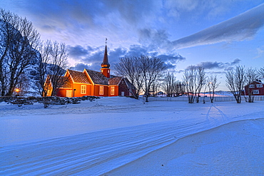 The red church of Flakstad surrounded by snow at dusk, Lofoten Islands, Arctic, Norway, Scandinavia, Europe