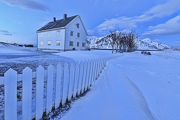 Typical house surrounded by snow at dusk, Flakstad, Lofoten Islands, Norway, Scandinavia, Europe