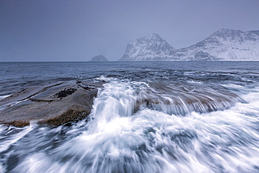 Waves crashing on the rocks of the cold sea, Haukland, Lofoten Islands, Northern Norway, Scandinavia, Arctic, Europe