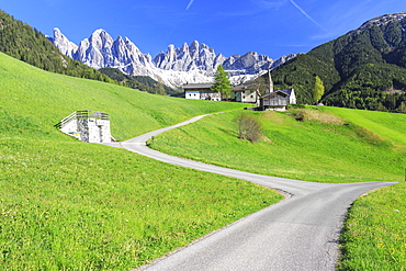 The village of St. Magdalene surrounded by green meadows at the foot of the Odle, Funes Valley, South Tyrol, Dolomites, Italy, Europe