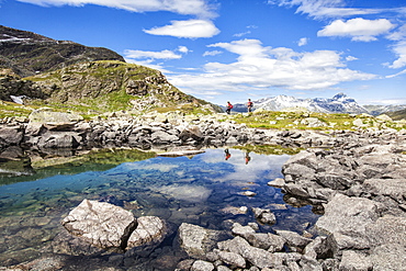 Hikers admire the view at Lake Grevasalvas, Engadine, Canton of Grisons (Graubunden), Switzerland, Europe