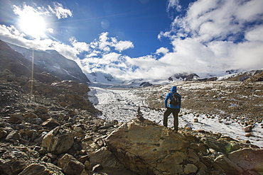 Hiker admires Forni Glacier, Cedec Valley, Stelvio National Park, Valtellina, Lombardy, Italy, Europe