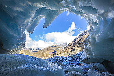 Hiker inside Forni Glacier, Forni Valley, Stelvio National Park, Valtellina, Lombardy, Italy, Europe