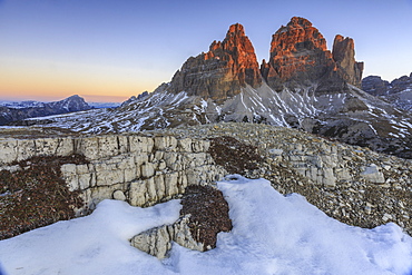 Pink sky at sunrise frames the Three Peaks of Lavaredo, Dolomites, Auronzo of Cadore, Veneto, Italy, Europe