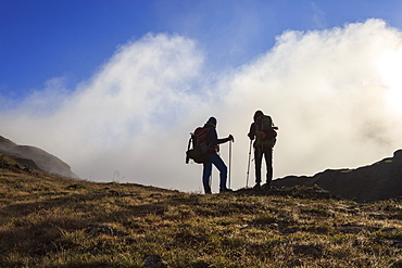 Hikers admire the landscape at dawn, Minor Valley, High Valtellina, Livigno, Lombardy, Italy, Europe