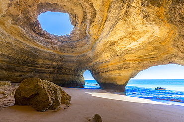 The sea caves of Benagil with natural windows on the clear waters of the Atlantic Ocean, Faro District, Algarve, Portugal, Europe