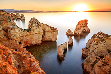 Golden sunrise on the  red cliffs of Ponta Da Piedade, Lagos, Algarve, Portugal, Europe