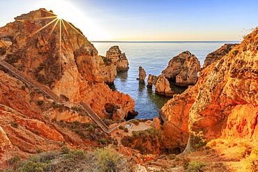 Golden sunrise on the red cliffs of Ponta Da Piedade, Lagos, Algarve, Portugal, Europe