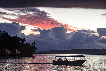 Tourist boat driving back home at sunset in Port Vila, Efate, Vanuatu, Pacific