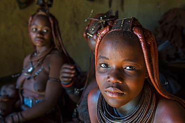 Friendly Himba women in their hut, Kaokoland, Namibia, Africa