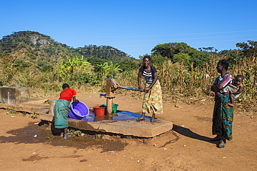 Local women at a water well, Malawi, Africa