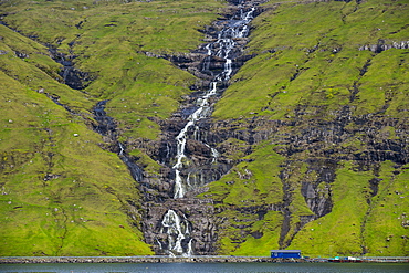 Waterfall tumbling down the hill, Streymoy, Faroe Islands, Denmark, Europe