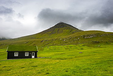 Lonely grass roofed house in Gjogv, Estuyroy, Faroe islands, Denmark