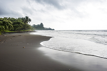 Black volcanic sand on six mile beach near Limbe, southern Cameroon, Africa