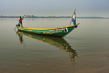 Man on his little boat before the former slave colony on Bunce island, Sierra Leone, West Africa, Africa