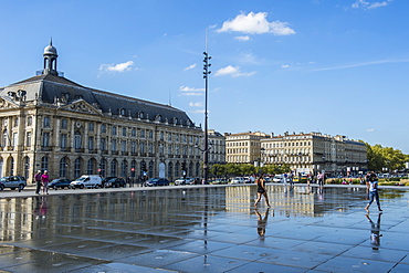 People standing in the water mirror on Place de la Bourse, Bordeaux, Aquiaine, France, Europe