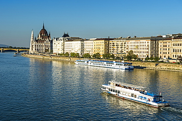 Little ferries on the River Danube in front of the Panorama of Pest, Budapest, Hungary, Europe