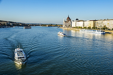 Little ferries on the River Danube in front of the Panorama of Pest, Budapest, Hungary, Europe