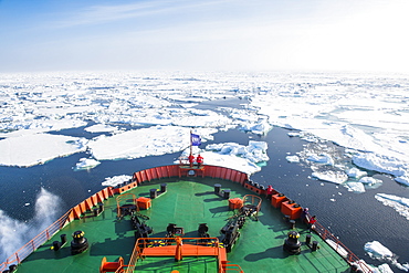 People enjoying the breaking ice on board of an icebreaker, North Pole, Arctic