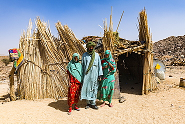 Tuareg family posing in front of their hut, near Tamanrasset, Algeria, North Africa, Africa