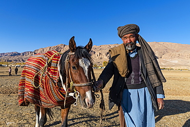 Old man with his horse at a Buzkashi game, Yaklawang, Afghanistan, Asia