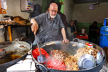 Man cooking food in a giant pot, Bird Street, Kabul, Afghanistan, Asia