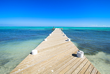 Long wooden pier in the turquoise waters of Providenciales, Turks and Caicos, Caribbean, Central America