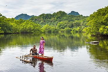 Couple in dugout canoe, Kosrae, Federated States of Micronesia, South Pacific