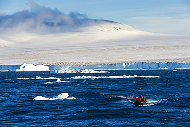 Zodiac with tourists cruising through the icebergs, Brown Bluff, Tabarin Peninsula, Antarctica, Polar Regions