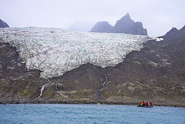 Tourists on a zodiac watching a glacier on Elephant Island, South Shetland Islands, Antarctica, Polar Regions