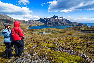 Tourists admiring the stunning scenery of Godthul, South Georgia, Antarctica, Polar Regions