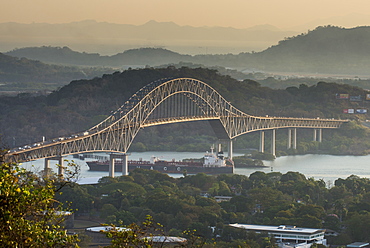 Cargo boat passes the Bridge of the Americas on the Panama Canal, Panama City, Panama, Central America