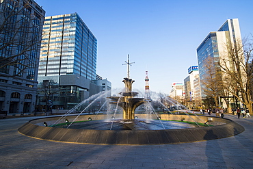 Fountain in the Odori Park, downtown Sapporo at sunset, Hokkaido, Japan, Asia