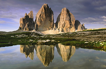 Dolomites, italy. South tyrol. Area of the three chimneys,from left to right: small chimney 2857 m; big chimney 2999 m; western chimney 2973 m; reflecting in a small puddle of water