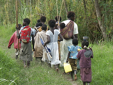 Zambia women and children walking to a lake for fishing