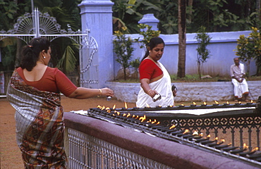 India - religion - christianity: lighting oil lamps at st. Marys, valiapally catholic church, kerala