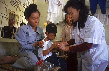 Vietnam - health: boy receiving acupuncture treatment, hanoi