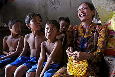 CAMBODIA Khoun Sokhoun, 44, former garbage scavenger, now maker of hats from recycled plastic bags and other items from recycled paper, benefciary of project run by local NGO CSARO which works with waste collectors in Phnom Penh. Seen here with her sons and orphaned nephews