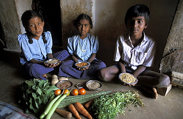 India children healthy vegetables and traditional seeds of horse, red, cow, and finger millet. Alaganahalli village, kolar, karnataka