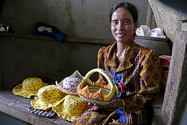 CAMBODIA Khoun Sokhoun, 44, former garbage scavenger, now maker of hats from recycled plastic bags and other items from recycled paper, benefciary of project run by local NGO CSARO which works with waste collectors in Phnom Penh. Here she is showing a basket made from recycled paper