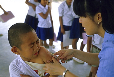 Thailand boy receiving immunization at a school in chiang mai